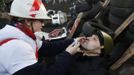 A medic cleans the eyes of an anti-government protester as he mans a barricade in Kiev February 21, 2014.