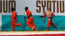 Track officials rush to remove debris from the track during the Malaysian F1 Grand Prix at Sepang International Circuit outside Kuala Lumpur, March 30, 2014. REUTERS/Edga