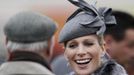 Britain's Zara Phillips smiles as she chats with friends in the parade ring during the Cheltenham Festival horse racing meet in Gloucestershire, western England March 13, 2012.