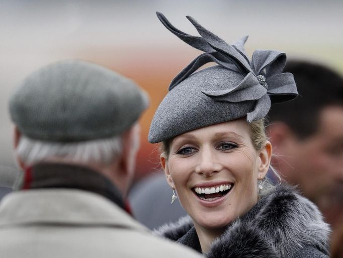 Britain's Zara Phillips smiles as she chats with friends in the parade ring during the Cheltenham Festival horse racing meet in Gloucestershire, western England March 13, 2012.