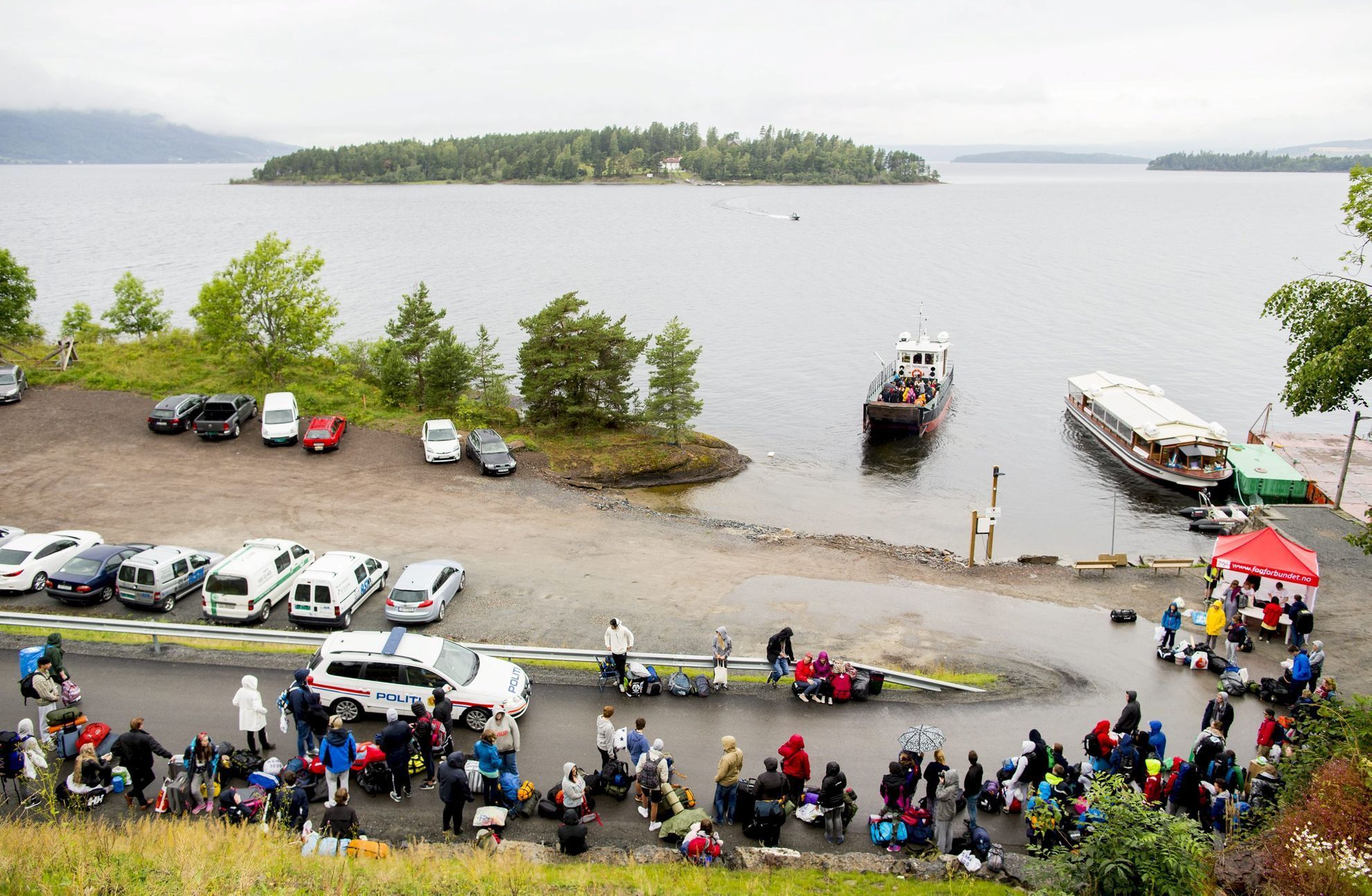 Youths stand in a line to wait for the MS Thorbjorn ferry to take them to Utoya island