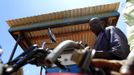 A fuel pump attendant serves a motorcyclist at a pump in Kogelo village, the ancestral home of U.S. President Barack Obama, at Nyangoma Kogelo shopping centre, 430 km (367 miles) west of Kenya's capital Nairobi, November 5, 2012. Four years ago, Kogelo, and Africa in general, celebrated with noisy gusto when Obama, whose father came from the scattered hamlet of tin-roofed homes, became the first African-American to be elected president of the United States. Looking across the Atlantic to the Nov. 6 presidential election, the continent is cooler now towards the "son of Africa" who is seeking a second term. There are questions too whether his Republican rival, Mitt Romney, will have more to offer to sub-Saharan Africa if he wins the White House. To match Analysis AFRICA-USA/ELECTION REUTERS/Thomas Mukoya (KENYA - Tags: SOCIETY ELECTIONS POLITICS USA PRESIDENTIAL ELECTION) Published: Lis. 5, 2012, 11:08 dop.