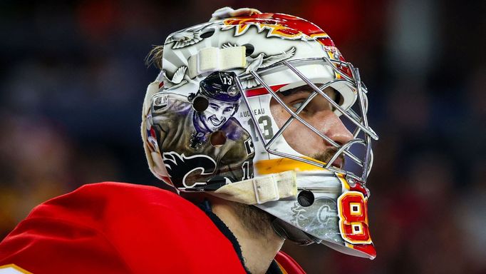 Dec 3, 2024; Calgary, Alberta, CAN; Calgary Flames goaltender Dan Vladar (80) pays tribute to the late Johnny Gaudreau on his mask during the third period against the Col