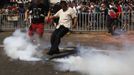 A demonstrator tries to kick a tear gas canister away during a protest against Japan's decision to purchase disputed islands, which Japan calls the Senkaku and China calls the Diaoyu, in Shenzhen, south China's Guangdong province September 16, 2012. Torrid protests against Japan flared in Chinese cities for a second day on Sunday, with the government struggling to find a balance between venting public anger and containing violence that could backfire ahead of a delicate leadership succession. REUTERS/Tyrone Siu (CHINA - Tags: POLITICS CIVIL UNREST)