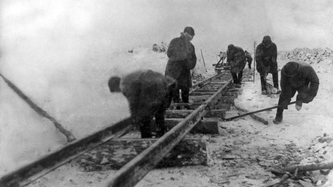 Vězni gulagu staví železniční trať.