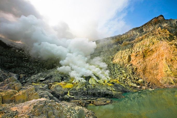 To go with story Indonesia-volcano-mine by Jerome Rivet A picture taken on April 26, 2010 shows Indonesian sulphur miner carrying blocks of sulphur down the Kawah Ijen, o