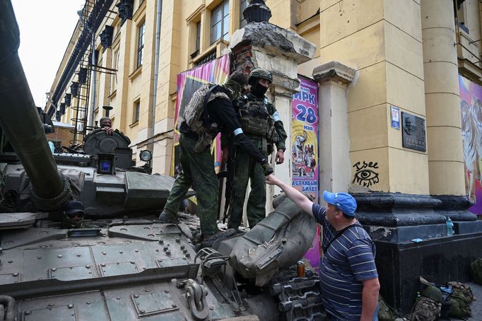 Lidé v ruském městě Rostov se zdraví s bojovníky Wagnerovy skupiny, kteří město obsadili.