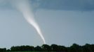 Milky White Tornado Spins Across Farmland Original caption:A tornado is a rapidly rotating column of air, made visible by the presence of dust or debris, or in the case of this twister, the condensation of water vapor due to the lowered pressure within the column.