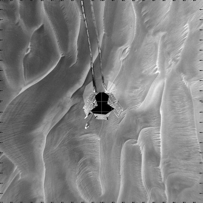 Opportunity's Sol 446 Position 5/6/05 This mosaic of navigation-camera frames from NASA's Mars Exploration Rover Opportunity, presented in a vertical projection, shows the rover's position after it dug itself to wheel-hub depth in a small dune during its 446th martian day, or sol (April 26, 2005). The elongated dune, or ripple, is about one-third of a meter (one foot) tall and 2.5 meters (8 feet) wide. Opportunity had completed nearly 40 meters (131 feet) of a planned 90-meter (295-foot) drive that sol when its wheels began slipping. The rover was driving backwards at the time. The rover team frequently alternates between backwards and forwards driving to keep wheel lubrication well distributed. The wheels kept rotating enough times to have covered the rest of the distance if they hadn't been slipping, but the rover eventually barely inched forward. After a turn at the end of the planned drive, Opportunity sensed that it had not turned properly and stopped moving. The rover team spent more than a week designing and conducting tests under simulated Mars conditions on Earth before choosing the best way for Opportunity to drive out of the dune. Image Credit: NASA/JPL