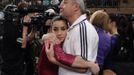 RNPS IMAGES OF THE YEAR 2012 - Alexandra Raisman (L) of the U.S. is hugged by her coach Mihai Brestyan after coming in second place during the AT American Cup gymnastics competition at New York's Madison Square Garden March 3, 2012. REUTERS/Mike Segar (UNITED STATES - Tags: SPORT GYMNASTICS) Published: Pro. 3, 2012, 1:07 dop.