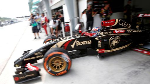 Lotus Formula One driver Romain Grosjean of France leaves the garage during the second practice session of the Malaysian F1 Grand Prix at Sepang International Circuit out