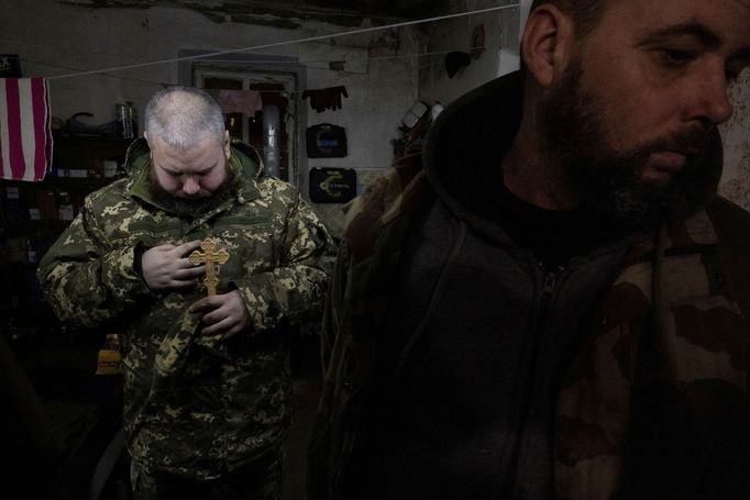 Military Chaplain Oleksandr leads a Christmas Day service for soldiers of the 93rd separate mechanized brigade near the front line in the Donetsk region as Ukrainians cel