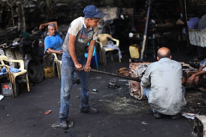 MIDEAST-GAZA-CHILD-LABOR (130604) -- Gaza, June 4, 2013 -- Palestinian boys work at a garage for repairing cars in Gaza city on June 4, 2013. Many boys left school to work in many different jobs to support their families. Child labor is widespread in the Gaza Strip because of the high rates of poverty.