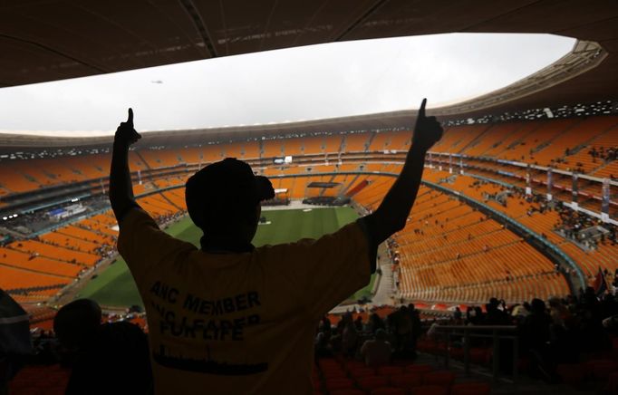 People arrive at the First National Bank (FNB) Stadium, also known as Soccer City, ahead of the national memorial service for late former South African President Nelson Mandela in Johannesburg December 10, 2013.