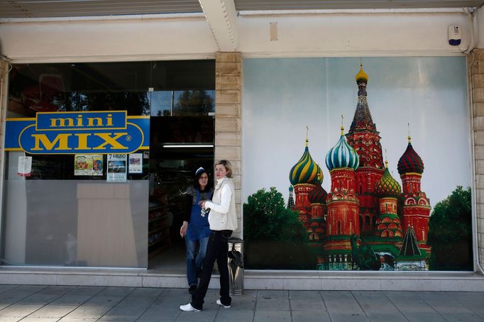 Two women talk outside a mini-market selling Russian products in Limassol, a coastal town in southern Cyprus, 2013