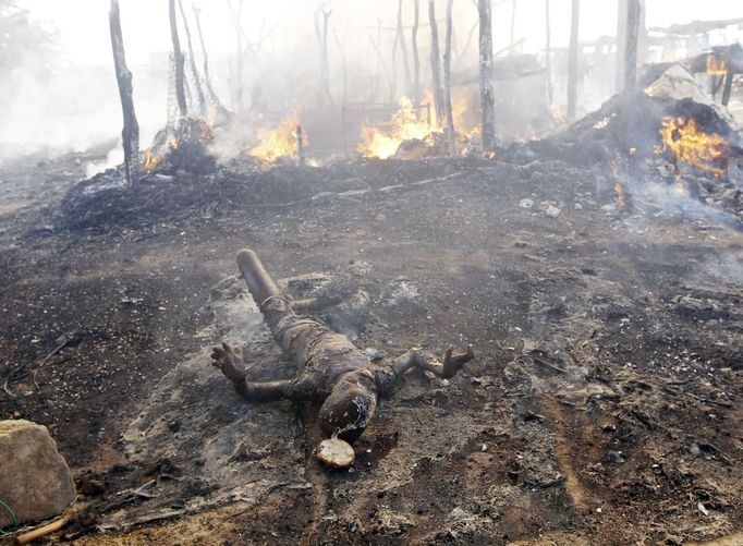 The burnt body of a boy killed during an air strike by the Sudanese air force lies on the ground in a market in Rubkona