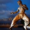 The staue of martial arts artist Bruce Lee is seen in front of the skyline at the Tsim Sha Tsui waterfront in Hong Kong