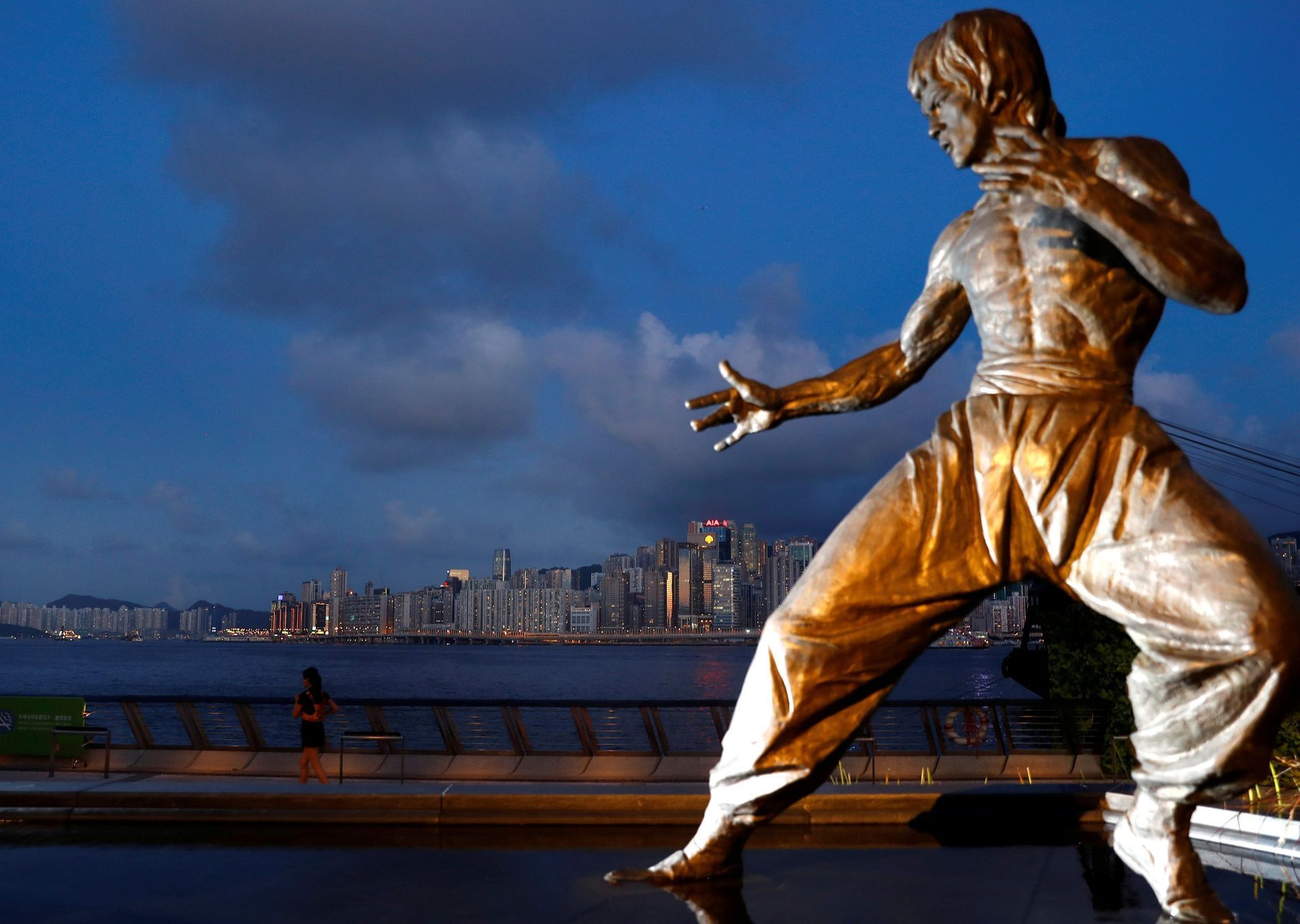 The staue of martial arts artist Bruce Lee is seen in front of the skyline at the Tsim Sha Tsui waterfront in Hong Kong