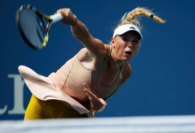 Caroline Wozniacki of Denmark serves to Maria Sharpova of Russia during their match at the 2014 U.S. Open tennis tournament in New York