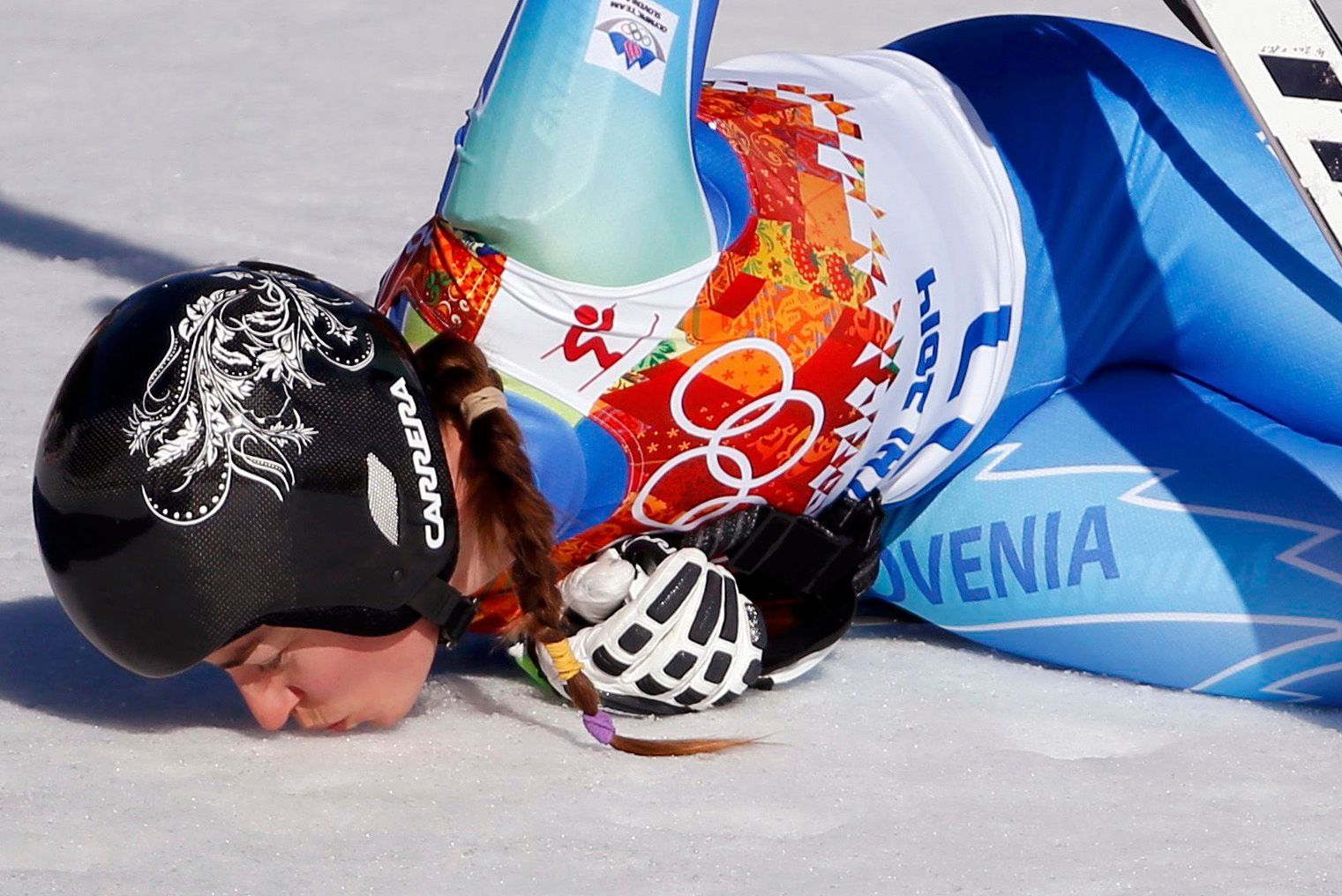 Slovenia's Tina Maze kisses the ground after winning the women's alpine