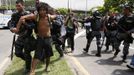 A supporter of the Native Indian community is arrested near the Brazilian Indian Museum in Rio de Janeiro March 22, 2013. Brazilian military police took position early morning outside the abandoned Indian museum, where a native Indian community of around 30 individuals have been living since 2006. The Indians were summoned to leave the museum in 72 hours by court officials since last week, local media reported. The group is fighting against the destruction of the museum, which is next to the Maracana Stadium. REUTERS/Sergio Moraes (BRAZIL - Tags: CIVIL UNREST POLITICS) Published: Bře. 22, 2013, 6 odp.