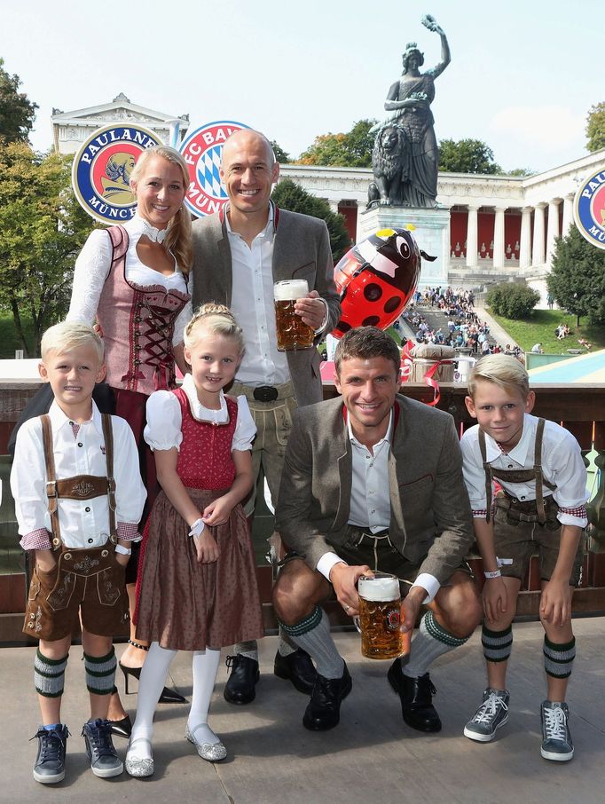 FC Bayern Munich's Robben, his wife Bernadien, their children and Mueller pose during their visit at the Oktoberfest in Munich