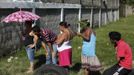 People stand near a crime scene where the dead body of a man was found after he was shot by gang members in San Pedro Sula March 28, 2013. San Pedro Sula, the country's second largest city after Tegucigalpa, has a homicide rate of 169 per 100,000 people and was named the world's most violent city for a second year in a row. Lax laws allow civilians to own up to five personal guns. Arms trafficking has flooded the country with nearly 70% illegal firearms. 83.4% of homicides are by firearms, compared to 60% in the United States. Picture taken March 28, 2013. REUTERS/Jorge Cabrera (HONDURAS - Tags: CRIME LAW CIVIL UNREST HEALTH) ATTENTION EDITORS: PICTURE 32 OF 39 FOR PACKAGE 'GUN CULTURE - HONDURAS' SEARCH 'HONDURAS GUN' FOR ALL IMAGES Published: Dub. 5, 2013, 11:15 dop.