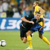 Anglický fotbalista Andy Carroll padá přes nohu Švéda Olofa Mellberga v utkání skupiny D na Euru 2012