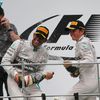 Mercedes Formula One driver Hamilton of Britain celebrates with team mate second-placed Rosberg of Germany and team engineer Shovlin after winning the Malaysian F1 Grand Prix at Sepang International C