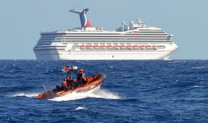 A small boat from the U.S. Coast Guard Cutter Vigorous patrols near the cruise ship Carnival Triumph in the Gulf of Mexico, in this February 11, 2013 handout photo. The cruise ship lost propulsion after an engine room fire on February 10 and was adrift off southern Mexico's Yucatan peninsula. REUTERS/U.S. Coast Guard/Lt. Cmdr. Paul McConnell/Handout (GULF OF MEXICO - Tags: MILITARY SOCIETY MARITIME TRANSPORT TRAVEL) FOR EDITORIAL USE ONLY. NOT FOR SALE FOR MARKETING OR ADVERTISING CAMPAIGNS. THIS IMAGE HAS BEEN SUPPLIED BY A THIRD PARTY AND WAS PROCESSED BY REUTERS TO ENHANCE QUALITY. AN UNPROCESSED VERSION WAS PROVIDED SEPARATELY Published: Úno. 11, 2013, 7:03 odp.