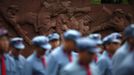 Mid-level government officials dressed in red army uniforms walk as they visit an old hospital during their 5-day training course at the communist party school called China Executive Leadership Academy of Jinggangshan, in Jiangxi province, in this September 21, 2012 file photo. China's Communist Party has dramatically stepped up its training of the country's roughly 40 million party and government officials in the past decade. With public scrutiny of cadre behaviour growing via social media, the party is likely to call for continued, and deepened, cadre education at the upcoming 18th Party Congress. At the vanguard of this education drive, alongside a Central Party School in Beijing, are three "Executive Leadership Academies" which opened in 2005 for middle-ranking and senior officials in Shanghai, Yan'an and Jinggangshan. The curriculum covers Marxism, Leninism and Mao Zedong Thought, but students may also take finance courses, receive in-depth media training or role-play crisis management scenarios on everything from disease outbreaks to train wrecks. REUTERS/Carlos Barria/Files (CHINA - Tags: POLITICS SOCIETY) Published: Zář. 24, 2012, 1:50 odp.