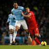 Liverpool's Suarez challenges Manchester City's Lescott  during their English Premier League soccer match at the Etihad stadium in Manchester
