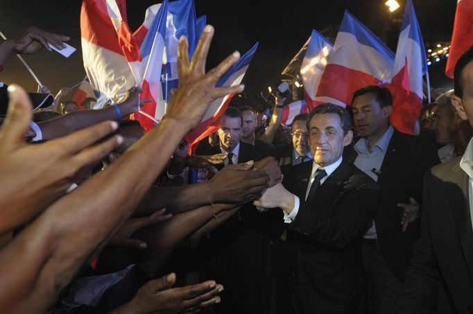 France's President and UMP party candidate for the 2012 French presidential elections Sarkozy shakes hands with supporters on the French indian Ocean island of La Reunion