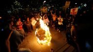 Snímek z centra Los Angeles, kde demonstranti pálí maketu hlavy příštího amerického prezidenta.