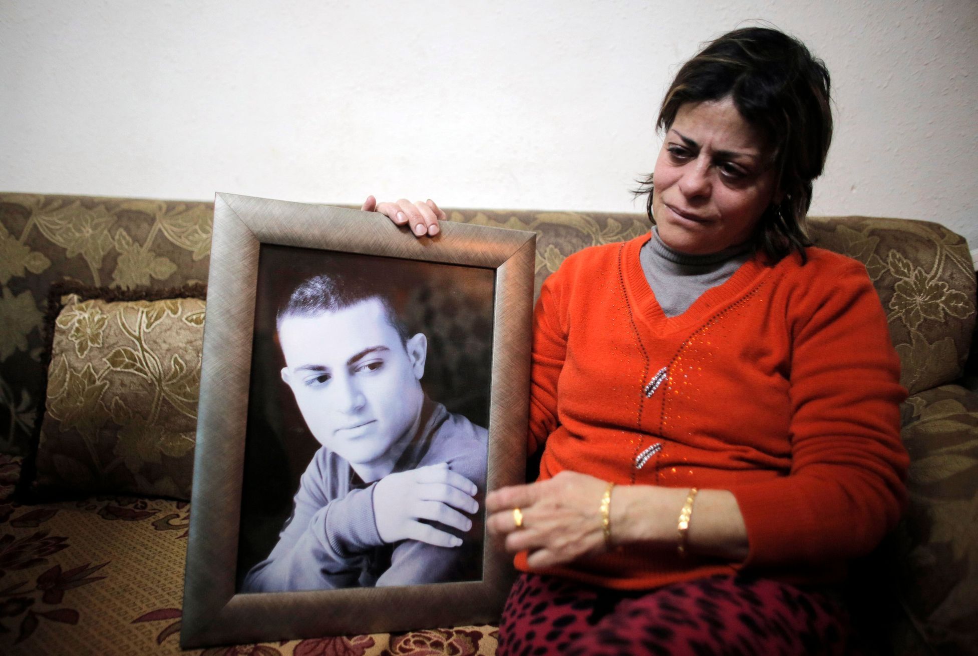 File photo of the mother of Muhammad Musallam, an Israeli Arab held by Islamic State in Syria as an alleged spy, weeping as she holds his photograph in her East Jerusalem home