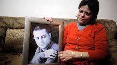File photo of the mother of Muhammad Musallam, an Israeli Arab held by Islamic State in Syria as an alleged spy, weeping as she holds his photograph in her East Jerusalem home