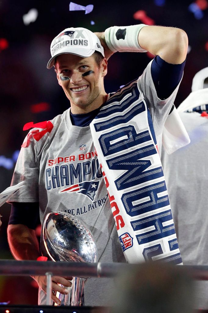 Feb 1, 2015; Glendale, AZ, USA; New England Patriots quarterback Tom Brady (12) celebrates with the Lombardi Trophy after beating the Seattle Seahawks in Super Bowl XLIX