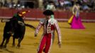 Spanish banderillero Mariscal runs ahead of a bull during a bullfight in Seville