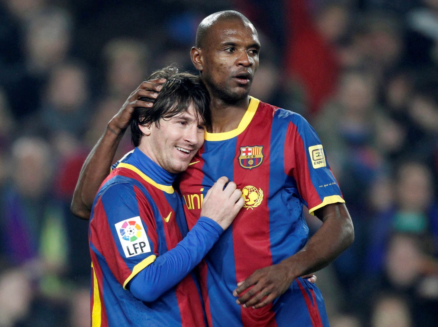 FILE PHOTO: Barcelona defender Abidal embraces teammate Messi after a goal against Atletico Madrid during their Spanish first division soccer match in Barcelona