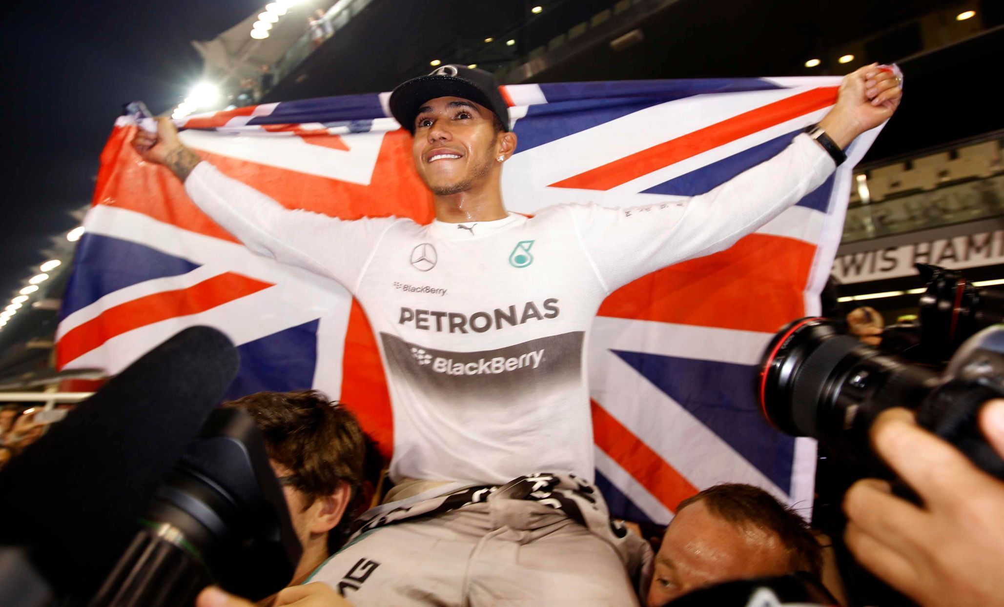 Mercedes Formula One driver Lewis Hamilton of Britain celebrates with his team after winning the Abu Dhabi F1 Grand Prix at the Yas Marina circuit in Abu Dhabi