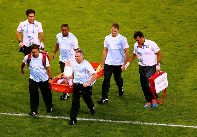 Chile's Charles Aranguiz is carried off the pitch during the 2014 World Cup Group B soccer match between Spain and Chile at the Maracana stadium in Rio de Janeiro June 18