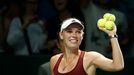 Caroline Wozniacki of Denmark prepares to hit balls to the audience after defeating Agnieszka Radwanska of Poland during their WTA Finals singles tennis match at the Sing