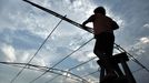 Performing With Lightning CHANGLE, CHINA - AUGUST 11: (CHINA OUT) Wang Zengxiang installs an iron shelf prior to a stunt performance on August 11, 2012 in Changle, Fujian Province of China. Wang Zengxiang, one of the craziest fans of the Tesla coil stunt, has dedicated himself in the daredevil career for a decade. He is now the leader of a band of four. A Tesla coil is an electrical resonant transformer circuit invented by Nikola Tesla around 1891. The transformer produces high voltage at high frequencies, which acts as a giant lightning machine, and creates long bolts of electricity. Shielded by protective clothing, the performer is insulated from the electricity current which dissipates through the ground. ( automatický překlad do češtiny )