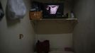 A television placed inside a wooden box used for living is seen in Hong Kong October 9, 2012. In Hong Kong's middle-class residential area, short distance from its shopping and financial districts, 24 people live in these wooden boxes, or "coffin homes", packed in a single apartment of little over 50 square meters. Its residents pay 1450 Hong Kong dollars ($180) for their living space built of wooden panels of 2 meters by 70 cm. To maximize income from the rent in central Hong Kong landlords build "coffin homes", nicknamed due to their resemblance to real coffins. Space has always been at a premium in Hong Kong where developers plant high-rises on every available inch. REUTERS/Damir Sagolj (CHINA - Tags: REAL ESTATE BUSINESS SOCIETY) Published: Říj. 9, 2012, 1:54 odp.