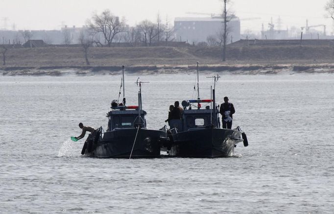 North Korean military personnel are seen on patrol boats on Yalu River near the North Korean town of Sinuiju, opposite the Chinese border city of Dandong, March 29, 2013. China called for an easing of tensions on Friday as North Korea put its missile units on standby to attack U.S. military bases in South Korea and the Pacific after the United States flew two nuclear-capable stealth bombers over the Korean peninsula. REUTERS/Jacky Chen