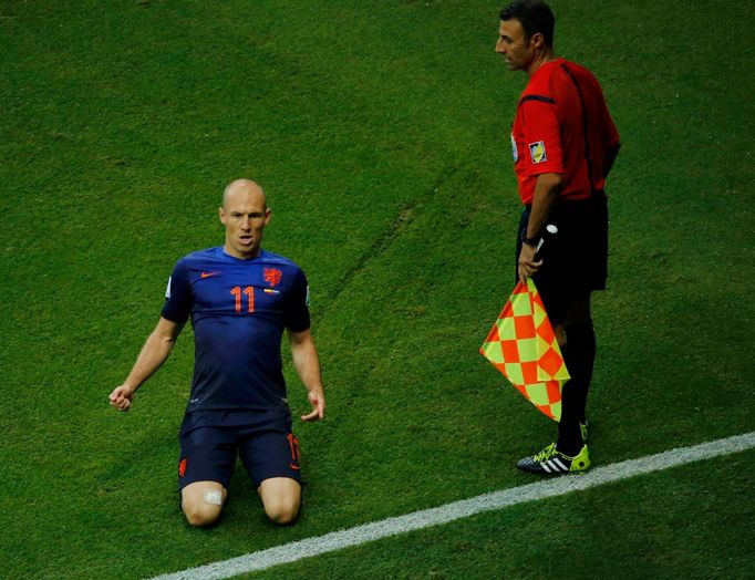 Arjen Robben of the Netherlands celebrates next to first assistant referee Renato Faverani of Italy after scoring a goal during their 2014 World Cup Group B match against