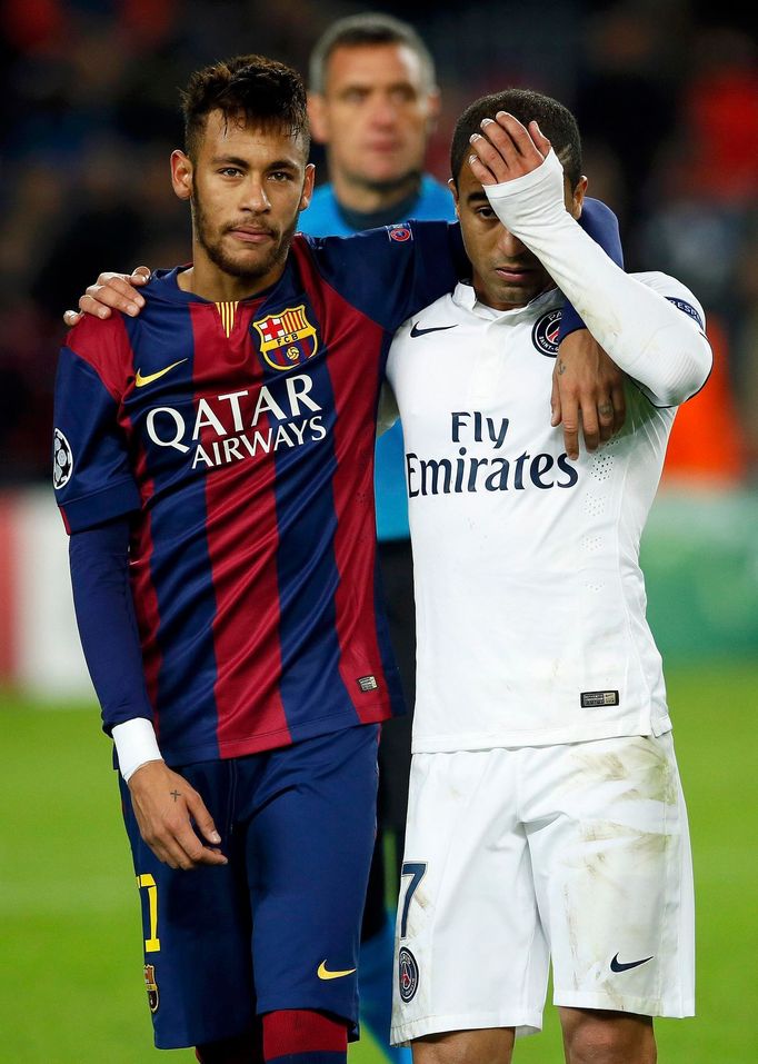 Paris St Germain's Lucas walks off the pitch with Barcelona's Neymar after their Champions League Group F soccer match at the Nou Camp stadium in Barcelona