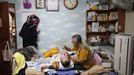 Pastor Lee Jong-rak feeds his 25-year-old son Lee Eun-man, who has cerebral palsy, at the Joosarang church in Seoul September 18, 2012. The South Korean pastor, who runs a "baby box" where mothers can leave unwanted infants, has seen a sharp increase in the number of newborns being left there because, the pastor says, of a new law aimed protecting the rights of children. South Korea is trying to shed a reputation of being a source of babies for adoption by people abroad. It is encouraging domestic adoption and tightening up the process of a child's transfer from birth mother to adoptive parents. Picture taken September 18, 2012. REUTERS/Kim Hong-Ji (SOUTH KOREA - Tags: SOCIETY) Published: Říj. 7, 2012, 6:52 dop.