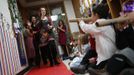 Jaidon Santos-Volpe (2nd R) uses a paper towel tube to "trumpet in" the arrival of his two mothers Theresa Volpe (2nd L) and Mercedes Santos (L) during the Valentine's Day Ball at Baker Demonstration School in Wilmette, Illinois, February 13, 2013. Santos and Volpe are a same-sex couple raising two of their biological children as they struggle to get same-sex marriages passed into law in Illinois. Picture taken February 13, 2013. REUTERS/Jim Young (UNITED STATES - Tags: SOCIETY) Published: Bře. 25, 2013, 6:06 odp.