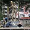 People decorate a statue of Argentine soccer great Diego Maradona before a prayer meeting, in Kolkata